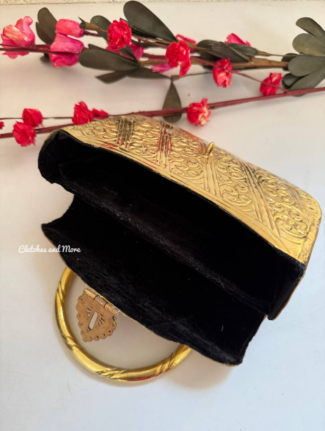 Anika Gold brass clutch with handle