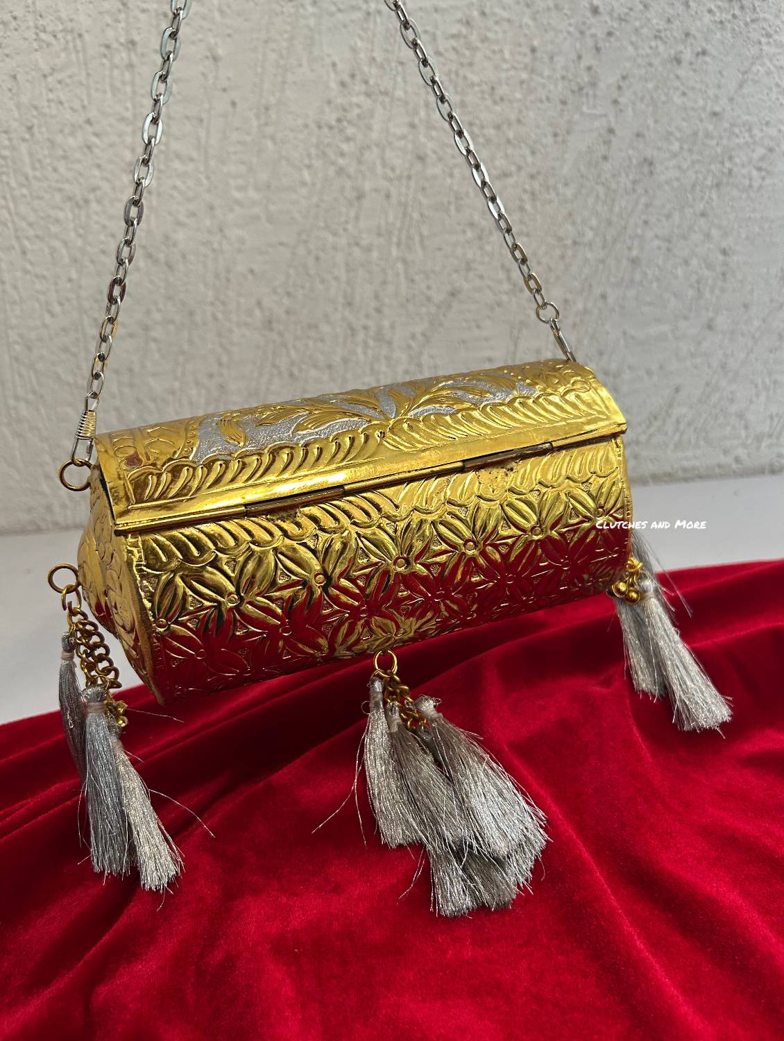 Vamika Cylindrical Gold Silver Brass Clutch with Tassles
