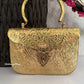 Anika Gold brass clutch with handle
