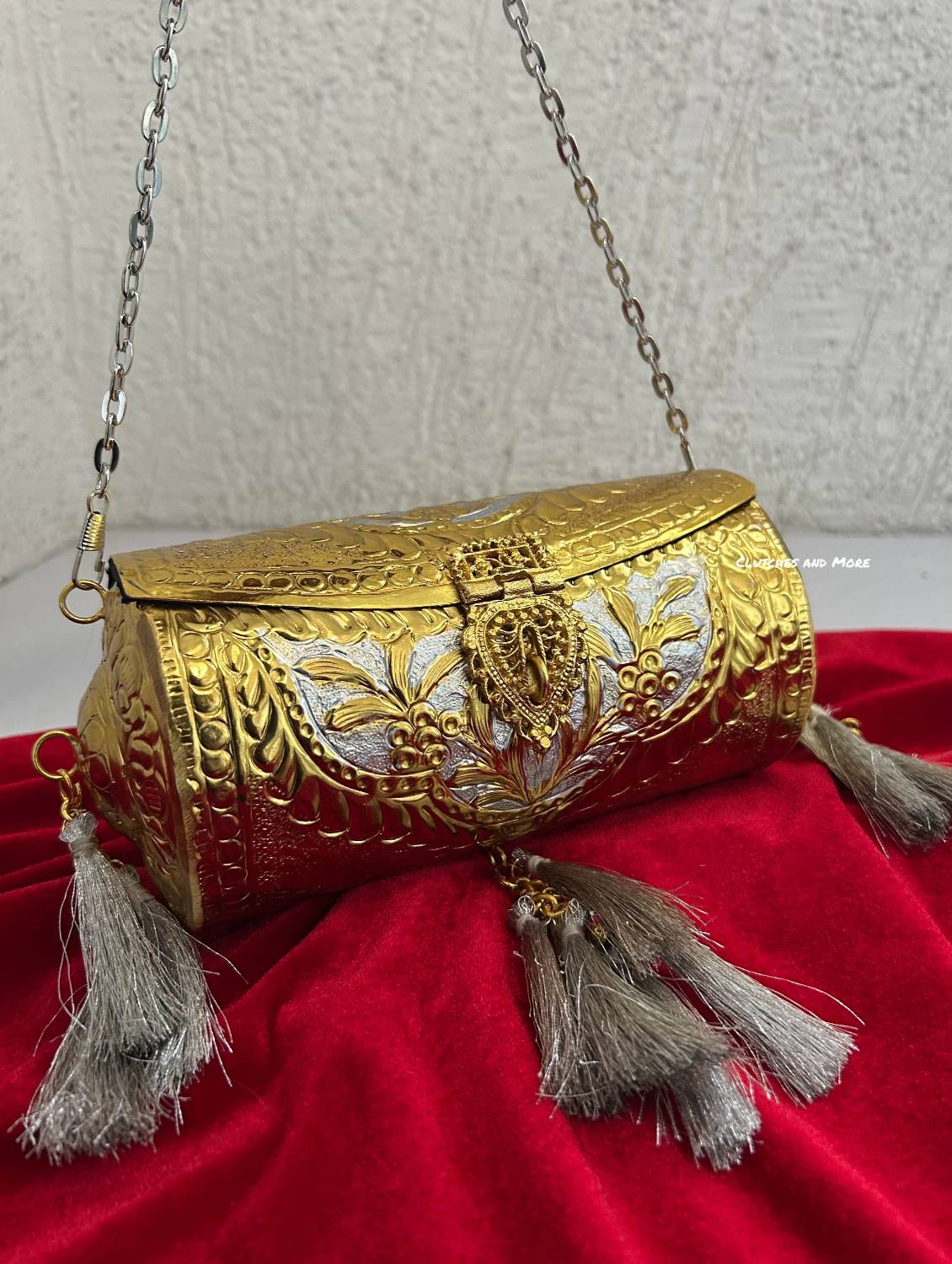 Vamika Cylindrical Gold Silver Brass Clutch with Tassles
