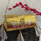 Vamika Cylindrical Gold Silver Brass Clutch with Tassles