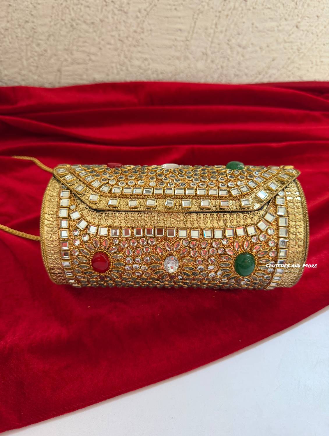 Kasika Kundan Brass Clutch Cylindrical ( with multicolored stones )