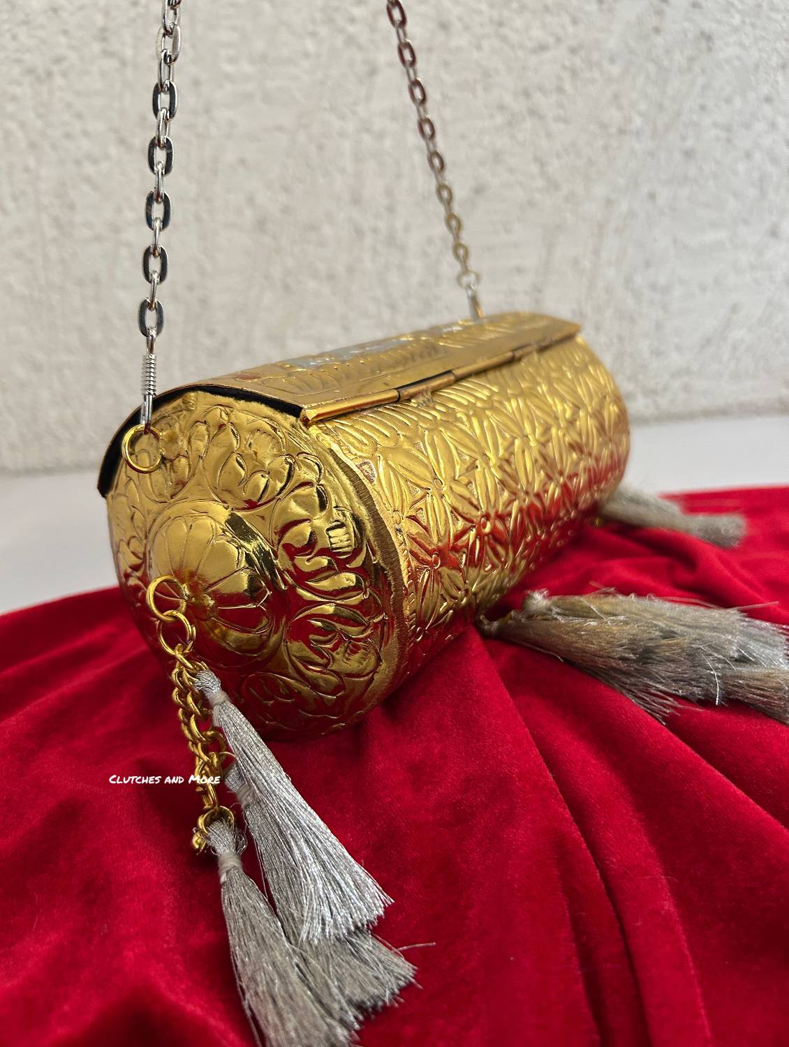 Vamika Cylindrical Gold Silver Brass Clutch with Tassles