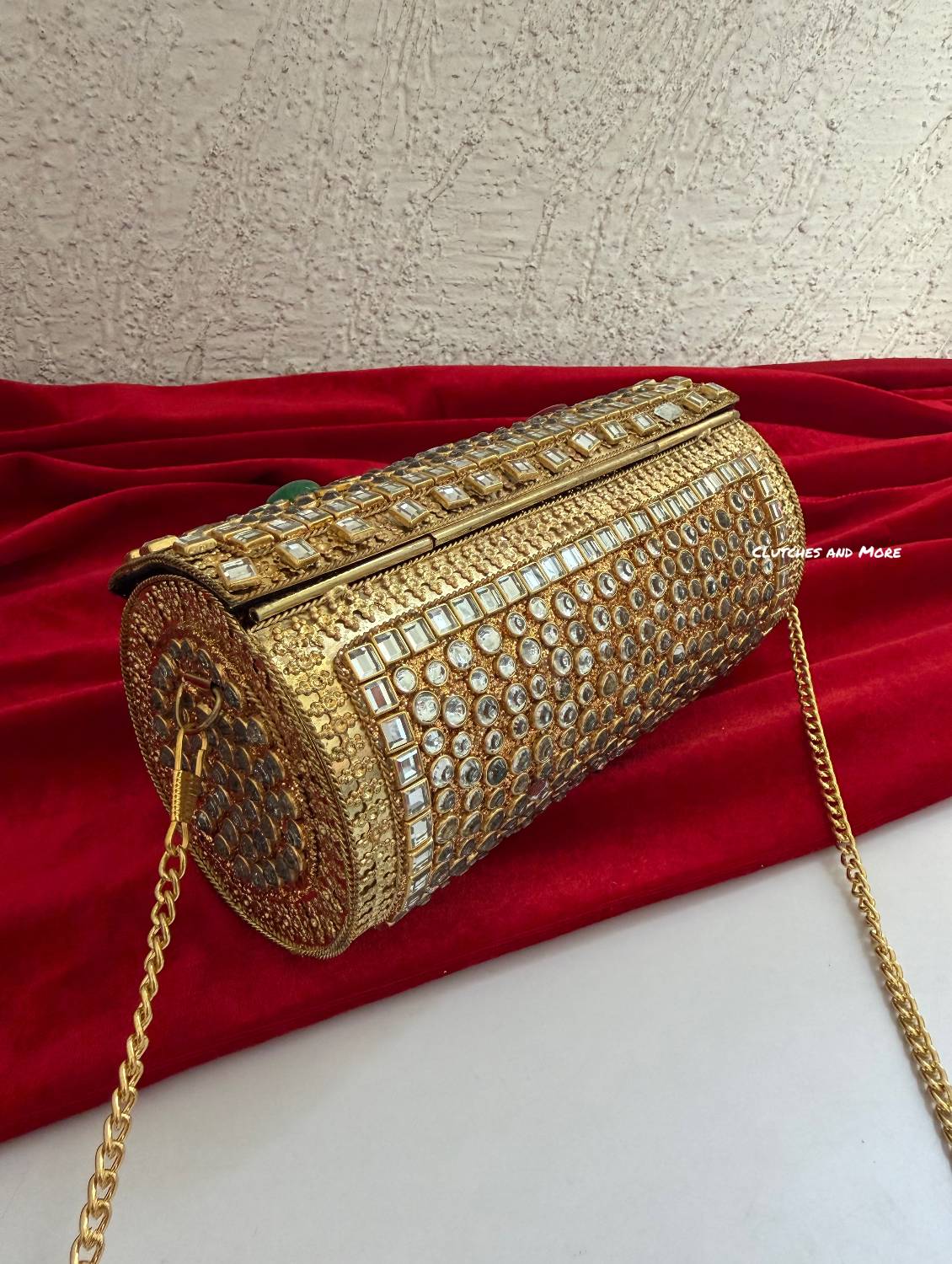 Kasika Kundan Brass Clutch Cylindrical ( with multicolored stones )