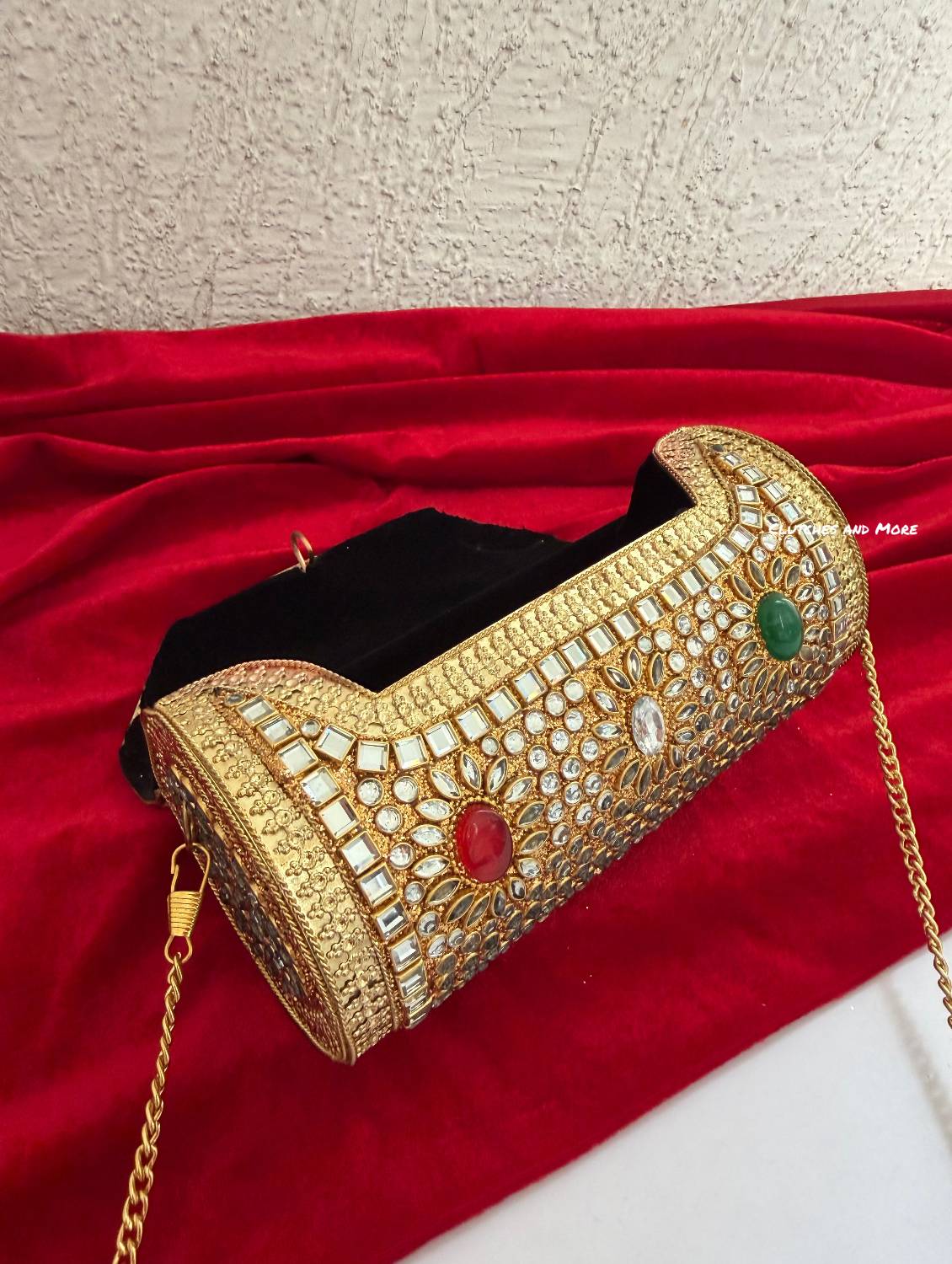 Kasika Kundan Brass Clutch Cylindrical ( with multicolored stones )